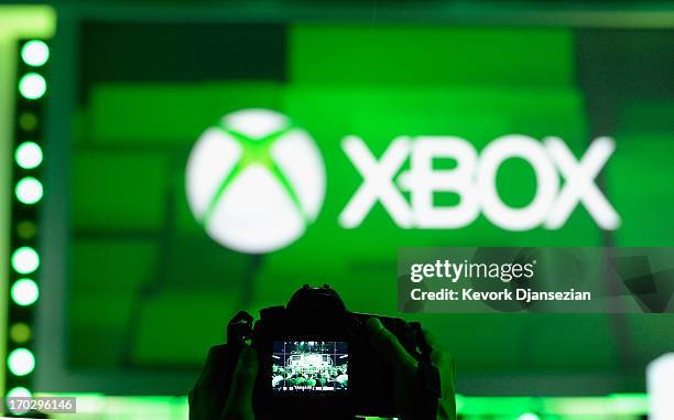 An attendee takes a photo of the XBOX logo during the Microsoft Xbox news conference at the Electronic Entertainment Expo at the Galen Center on June...