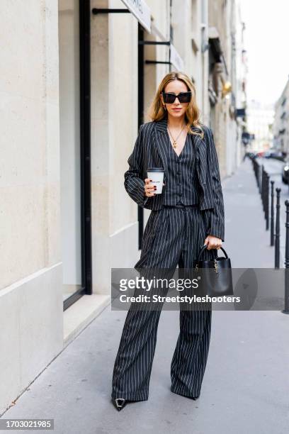 Influencer Alexandra Lapp, wearing a twelve by Britta Becker suit, a black bag by Saint Laurent, sunglasses by Saint Laurent and heels by Saint...