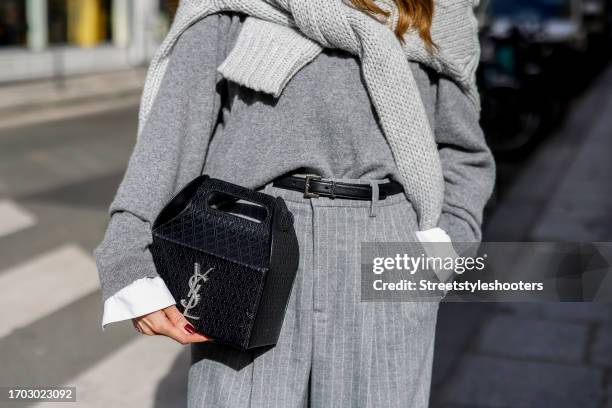 Influencer Alexandra Lapp, wearing a Seidensticker blouse in white, Rossi pinstriped pants in grey, a H&M cashmere sweater in grey, a Allude knit...