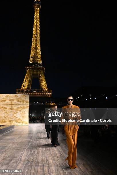 Models walk the runway in front of the Eiffel Tower during the Saint Laurent Womenswear Spring/Summer 2024 show as part of Paris Fashion Week on...