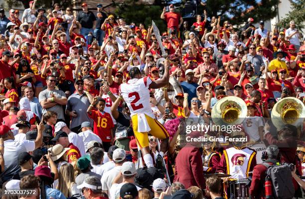 Trojans wide receiver Brenden Rice stands on a ladder with sword in hand to chant the USC fight song with the crowd after a 48-40 win over Colorado...