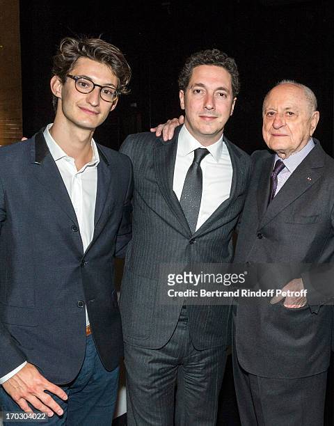 Actors Pierre Niney, Guillaume Gallienne and entrepreneur Pierre Berge pose during a tribute to late fashion designer Yves Saint Laurent at Opera...