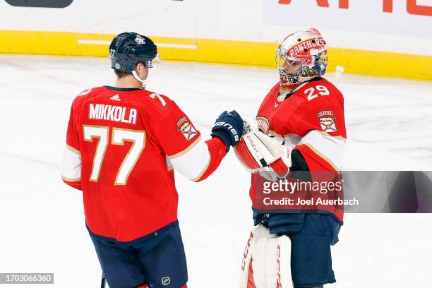 Goaltender Mack Guzda is congratulated by Niko Mikkola of the Florida Panthers after the 5-2 win against the Nashville Predators during a preseason...