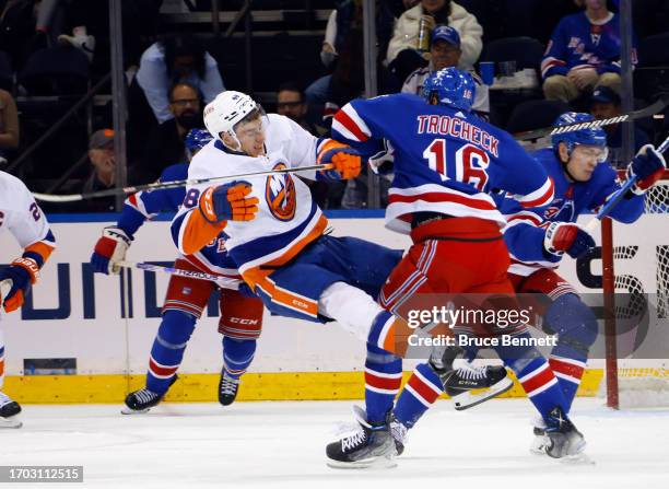 Vincent Trocheck of New York Rangers takes a kneeing penalty against Matthew Maggio of New York Islanders during a preseason game at Madison Square...