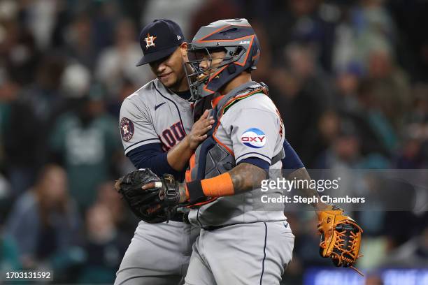 Relief pitcher Bryan Abreu celebrates with Houston Astros catcher Martin Maldonado after beating the Seattle Mariners 5-1 at T-Mobile Park on...