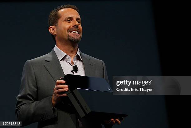 Andrew House, President and Group CEO Sony Computer Entertainment Inc., holds up a Playstation 4 at the Sony Playstation E3 2013 press conference...