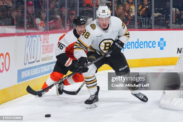 Patrick Brown of the Boston Bruins controls the puck against Bobby Brink of the Philadelphia Flyers in the third period of the preseason game at the...