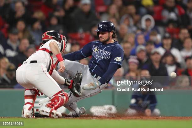 Joshua Lowe of the Tampa Bay Rays slides past Connor Wong of the Boston Red Sox during the third inning at Fenway Park on September 26, 2023 in...