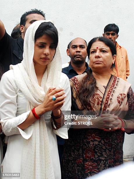 Indian Bollywood actress Priyanka Chopra is accompanied by her mother Madhu Chopra as she attends the funeral of her father Ashok Chopra in Mumbai on...