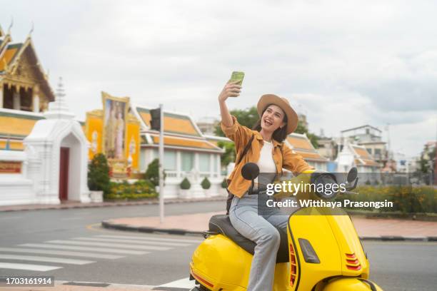 tourist selfie with wat suthat explore bangkok on a scooter - sable zen stock pictures, royalty-free photos & images