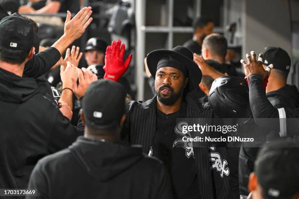 Eloy Jimenez of the Chicago White Sox is congratulated by teammates in the dugout following a three-run home run during the first inning against the...