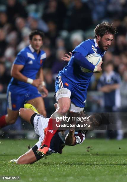 Maxime Medard of France is tackled during the tour match between the Auckland Blues and France at North Harbour Stadium on June 11, 2013 in Auckland,...