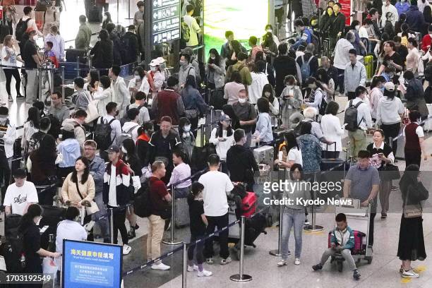 Beijing Capital International Airport departure lobby is crowded with people flying out of the Chinese capital on Sept. 29 ahead of National Day on...