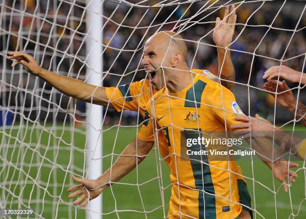 Mark Bresciano of Australia is congratulated by team mates after scoring a goal during the FIFA World Cup Qualifier match between the Australian...