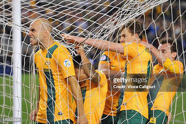 Mark Bresciano of Australia is congratulated by team mates after scoring a goal during the FIFA World Cup Qualifier match between the Australian...
