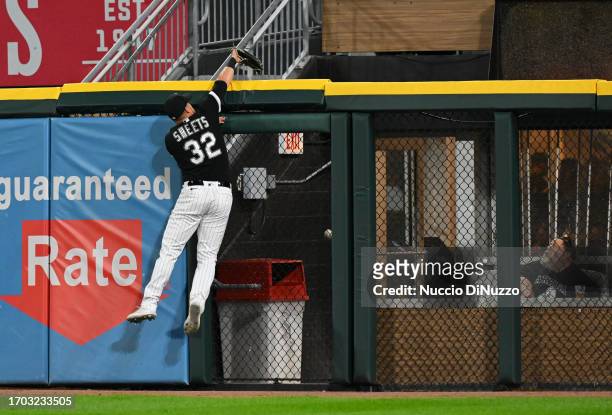 Gavin Sheets of the Chicago White Sox jumps to the wall and is unable to catch the home run ball hit by Christian Walker of the Arizona Diamondbacks...