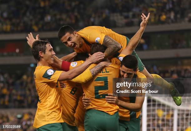 Tim Cahill and the Australians celebrate after Lucas Neill of the Socceroos scored a goal during the FIFA World Cup Qualifier match between the...