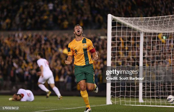 Lucas Neill of the Socceroos celebrates after scoring a goal during the FIFA World Cup Qualifier match between the Australian Socceroos and Jordan at...