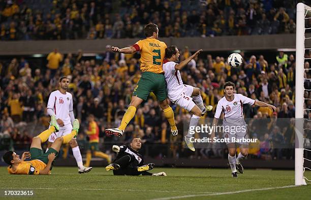 Lucas Neill of the Socceroos scores a goal during the FIFA World Cup Qualifier match between the Australian Socceroos and Jordan at Etihad Stadium on...