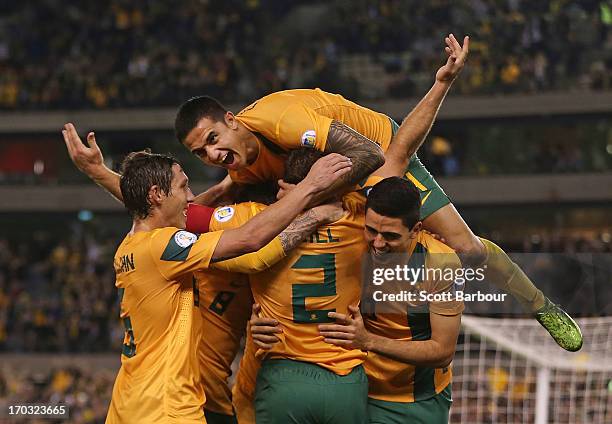 Tim Cahill and the Australians celebrate after Lucas Neill of the Socceroos scored a goal during the FIFA World Cup Qualifier match between the...