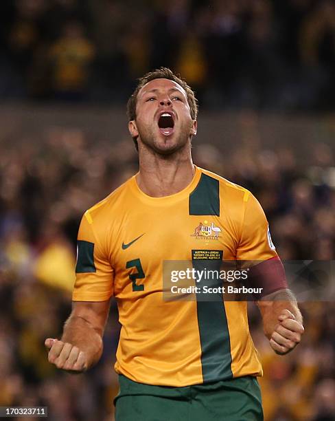 Lucas Neill of the Socceroos celebrates after scoring a goal during the FIFA World Cup Qualifier match between the Australian Socceroos and Jordan at...