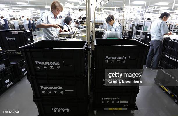 Workers assemble Panasonic Corp.'s Let's Note laptop computers on the production line at the company's plant in Kobe City, Hyogo Prefecture, Japan,...