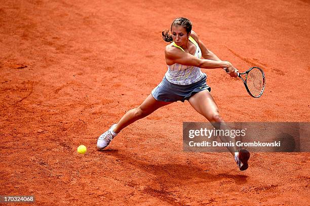 Annika Beck of Germany plays a backhand in her first round match against Nina Bratchikova of Russia during day four of the Nuernberger Insurance Cup...