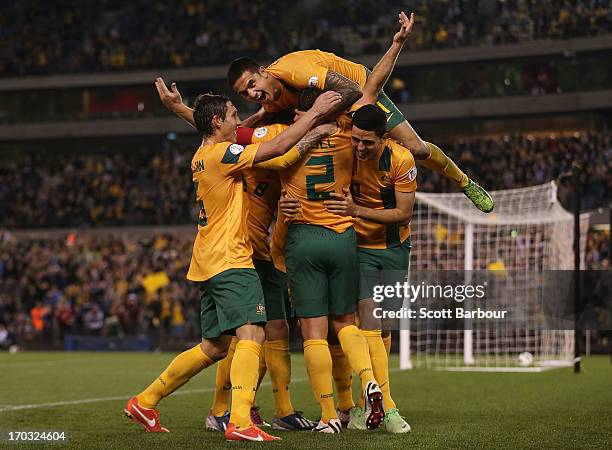 Tim Cahill and the Australians celebrate after Lucas Neill of the Socceroos scored a goal during the FIFA World Cup Qualifier match between the...
