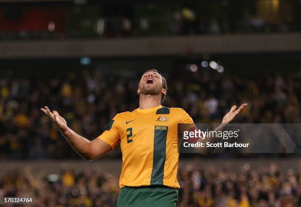 Lucas Neill of the Socceroos celebrates after scoring a goal during the FIFA World Cup Qualifier match between the Australian Socceroos and Jordan at...