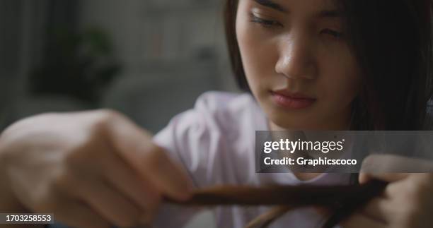 depressed unhappy ill young asian woman holding hair - dismissal cricket stock pictures, royalty-free photos & images