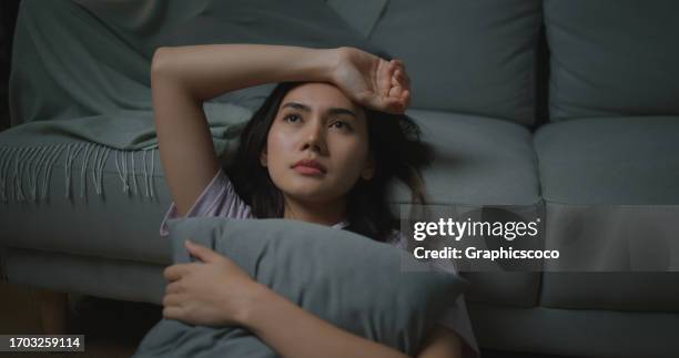 depressed young asian woman hugging pillow - dismissal cricket stock pictures, royalty-free photos & images