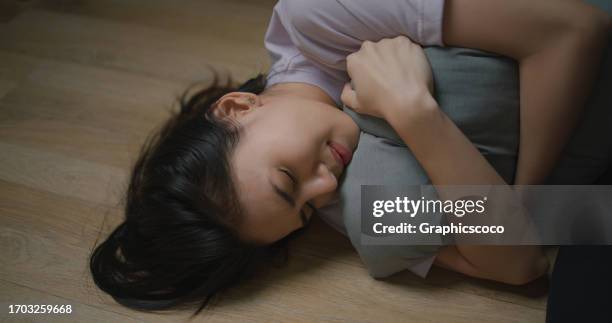 depressed young asian woman hugging pillow - dismissal cricket stock pictures, royalty-free photos & images