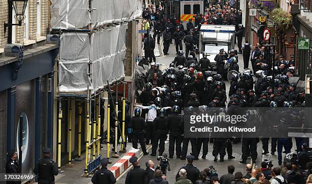 Police are seen on Beak Street as a man is searched as arrests are reportedly made as activists occupy a convergence centre of the Stop G8 protest...