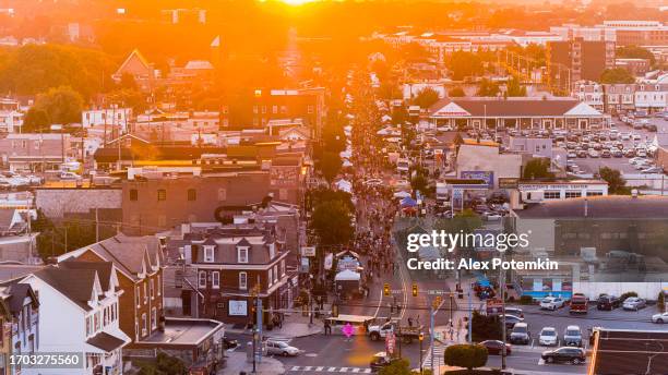 police control blocked streets during fall festival on sunset. densely streets, food trucks, and entertainment tents on autumn street festival. drone view - reading pennsylvania stock pictures, royalty-free photos & images