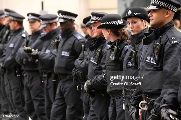 Police line the street on Piccadilly after activists occupied a convergence centre of the Stop G8 protest group off Beak Street ahead of next week's...