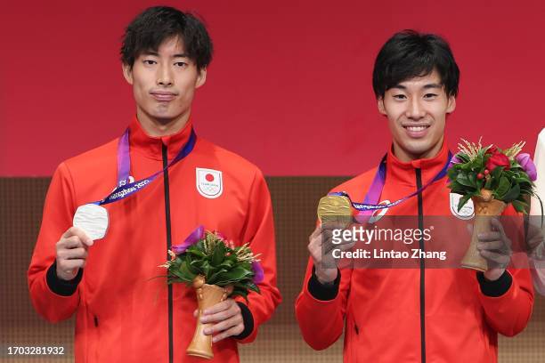Silver medalist Akira Komata and gold medalist Koki kano of Japan celebrates on the podium after the Men's Épée Individual Gold Medal Bout march...