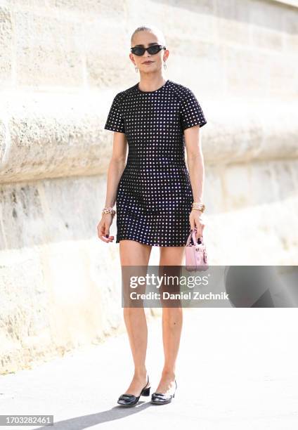 Caroline Daur is seen wearing a Dior dress, black sunglasses and black shoes outside the Dior show during the Womenswear Spring/Summer 2024 as part...