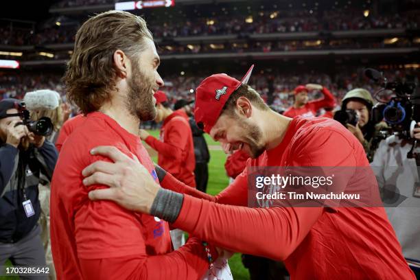 Bryce Harper and Trea Turner of the Philadelphia Phillies react after defeating the Pittsburgh Pirates at Citizens Bank Park on September 26, 2023 in...