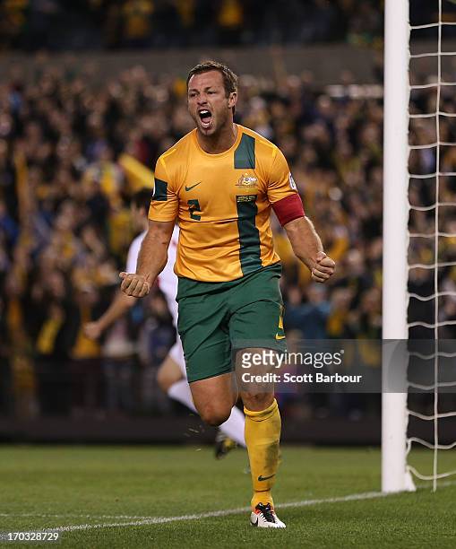Lucas Neill of the Socceroos celebrates after scoring a goal during the FIFA World Cup Qualifier match between the Australian Socceroos and Jordan at...