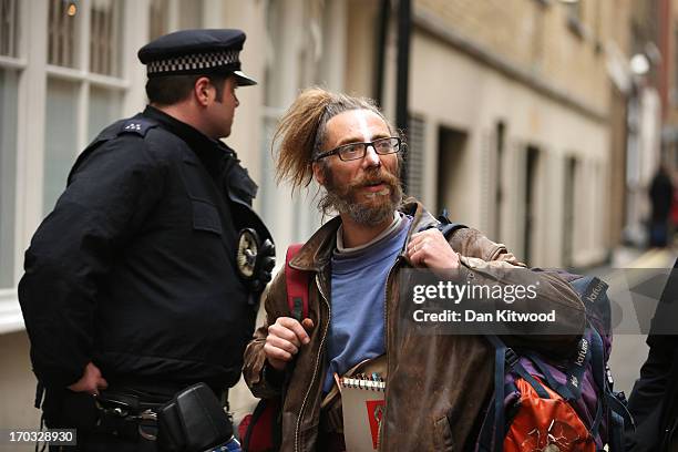 An activist is seen leaving the convergence centre of the Stop G8 protest group they occupied off Beak Street as after police detained some of the...