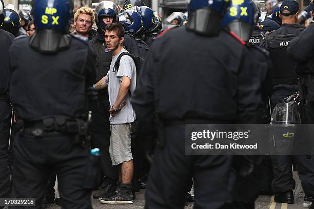 Protesters are led from a building they had been occupying on Beak Street in Soho, as part of a protest ahead of next week's G8 summit in Northern...