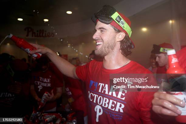 Aaron Nola of the Philadelphia Phillies reacts with teammates after clinching an NL Wild Card berth at Citizens Bank Park on September 26, 2023 in...