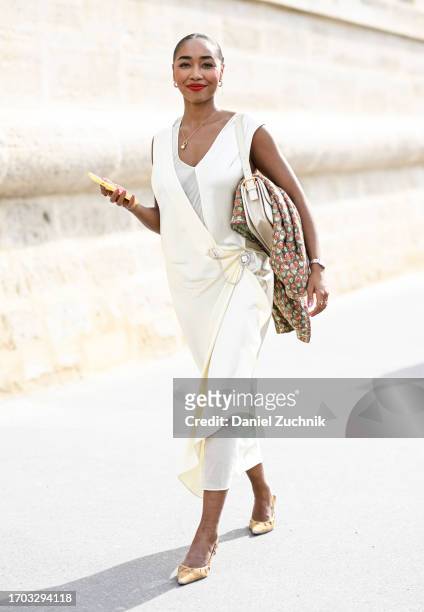 Guest is seen wearing a white dress and gold shoes outside the Dior show during the Womenswear Spring/Summer 2024 as part of Paris Fashion Week on...