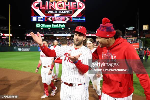 Bryce Harper and Taijuan Walker of the Philadelphia Phillies react with teammates after defeating the Pittsburgh Pirates to clinch an NL Wild Card...