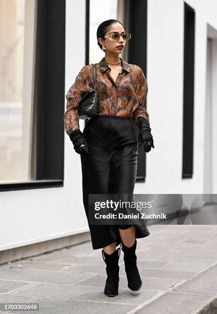 Malvika Sheth is seen wearing a YSL shirt, black Anine Bing skirt, black Anine Bing boots and YSL bag outside the Dior show during the Womenswear...