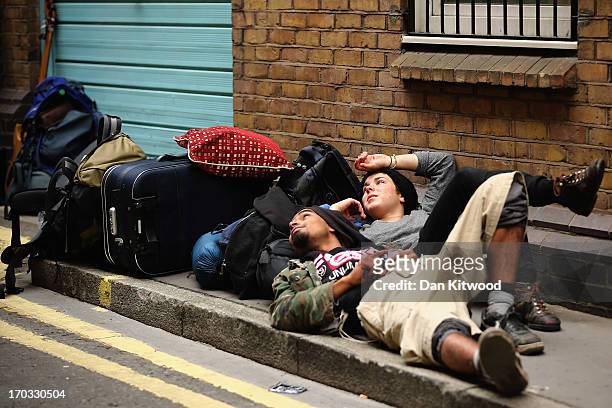 Protesters relax after being led from a building they had been occupying on Beak Street in Soho, as part of a protest ahead of next week's G8 summit...