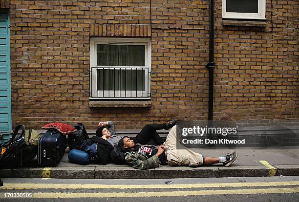Protesters relax after being led from a building they had been occupying on Beak Street in Soho, as part of a protest ahead of next week's G8 summit...