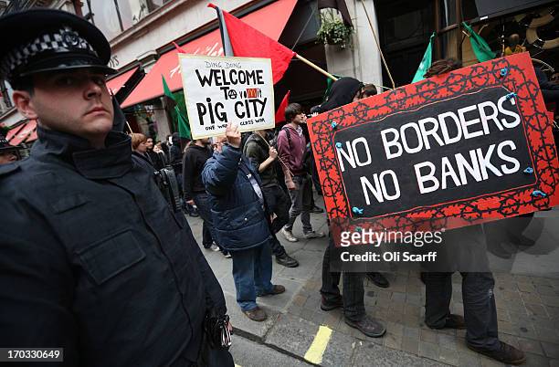 Protesters are seen holding placards during a demonstration on Regent Street as part of a protest ahead of next week's G8 summit in Northern Ireland...