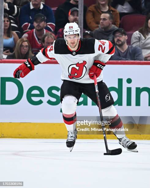 Colin Miller of the New Jersey Devils skates the puck during the first period against the Montreal Canadiens at the Bell Centre on September 25, 2023...