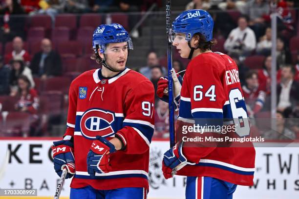 Joshua Roy and teammate David Reinbacher of the Montreal Canadiens speak during the first period against the New Jersey Devils at the Bell Centre on...